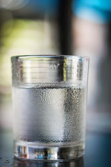 Glasses water on a table.