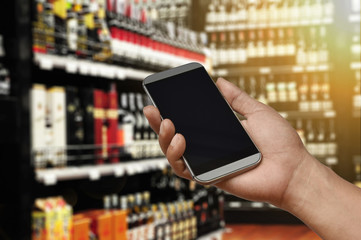 a hand holding smartphone on Wine Supermarket store