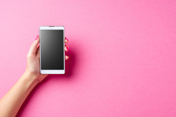 Woman holding white smart phone. Close up