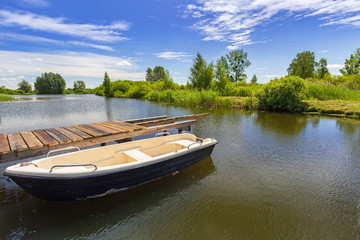 Fototapeta na wymiar Fishing boat at the lake in summer time, Poland