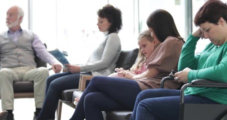 Patients waiting in a crowded hospital waiting room - Powered by Adobe