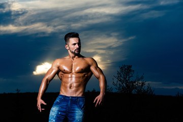 coach man with muscular body on blue sky