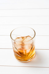 Whiskey glass on white wooden table. Close up