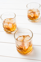 Whiskey glasses on white wooden table. Close up