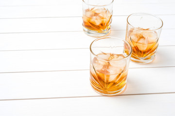 Whiskey glasses on white wooden table. Close up