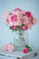 Close-up floral composition with a pink roses .Many beautiful fresh pink roses on a table. 
