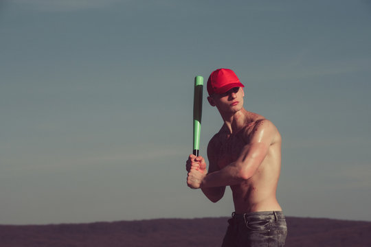 Athlete Man In Red Cap Holding Baseball Bat