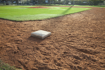 Baseball field infield with first base in the foreground