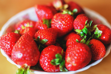 Fresh ripe strawberry in a plate, selective focus