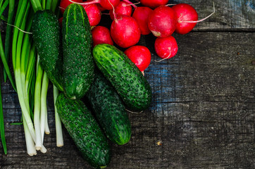 Radish cucumbers and green onion on wooden table. Top view
