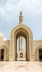 Fototapeta na wymiar Courtyard and ornate arch leading to a minaret