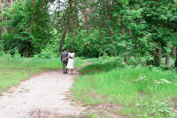 Fototapeta premium The bride and groom walk in the woods