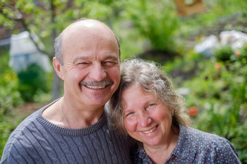 Loving Mature Couple In Back Yard Garden in Sunny Day