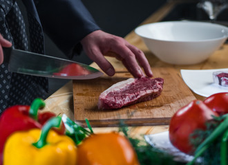 man is cooking a steak