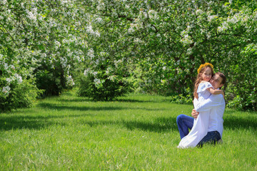 Obraz premium Father and daughter in nature. Hugging each other. Happy family.