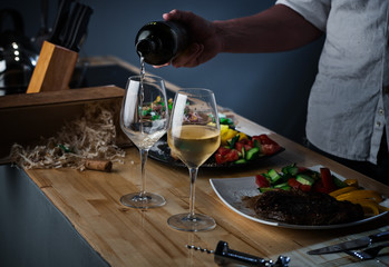 White wine is poured by glasses