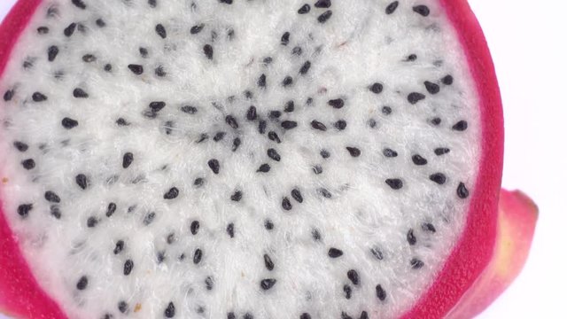 Juicy tropical dragon fruit rotates. Close-up of pitahaya on white background.