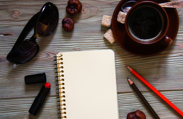 Top view of notebook and fashion accessories