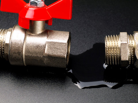water leaking from disconnected valve and fitting, closeup
