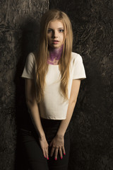Wonderful blonde model with bright makeup and violet glitter on her neck