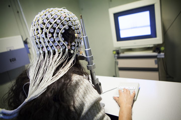 Female patient under EEG test in operating room