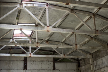 Cement beams inside an old building on the ceiling, bottom view