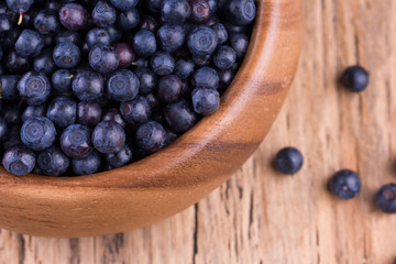 Blueberries in a bowl on a vintage wooden table. Bilberry on wooden Background. Blueberry antioxidant.