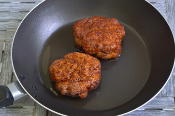 Meatballs in a Frying pan / two meatballs in a frying pan, close up, macro, full frame
 