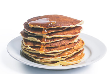 homemade pancakes with maple syrup, closeup toned photo
