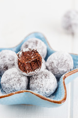 Bitten chocolate truffle in sugar powder
