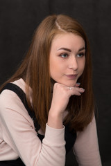 Emotionally young girl with blond hair posing