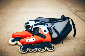 Roller skates orange color on asphalt