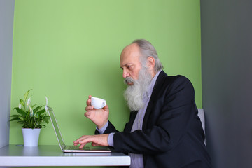 Experienced businessmen retired communicates via skype using gad © sisterspro