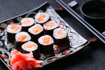 Sushi rolls with salmon, soy sauce and chopsticks 
