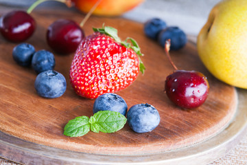 Fresh fruits on a wooden cutting board