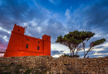 Il-Mellieha, Malta - St Agatha's Red Tower at blue hour with tree and beautiful clouds and sky