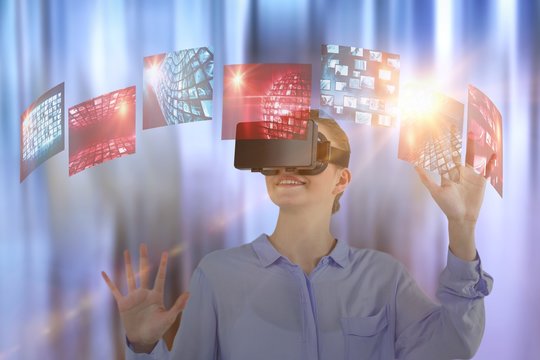 Composite image of businesswoman experiencing virtual reality