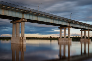 Common river bridge at cloudy day