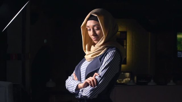Headshot of young muslim girl with hijab headscarf. Slow motion. Portrait of an attractive young modern Muslim woman in hijab.