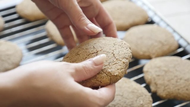 Slow motion bread product picking and halving from baking rack 1080p FullHD footage - Close-up breaking homemade cookie on two pieces slow-mo 1920X1080 HD video