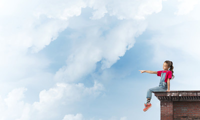 Concept of careless happy childhood with girl showing touch gesture