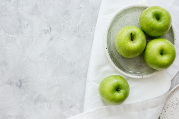 Healthy green food with apples on plates stone background top view mock up