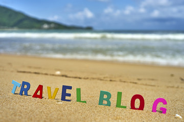 Naklejka premium TRAVEL BLOG wood letters on the beach