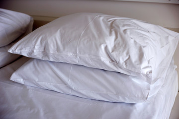 Pillows on bed in hotel room