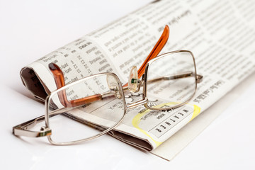 Reading glasses on the newspaper