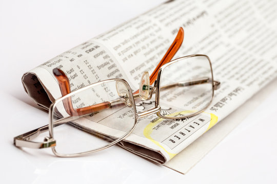 Reading glasses on the newspaper