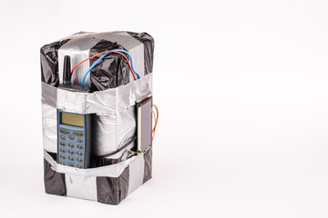bomb with screen, cell phone and colored wires on a white background. Terrorism and military concept