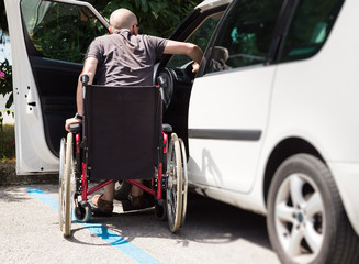 Fototapeta na wymiar Adult Driver In Wheelchair Getting Into The Car