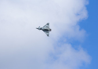 Modern jet fighter flying high in the sky. 