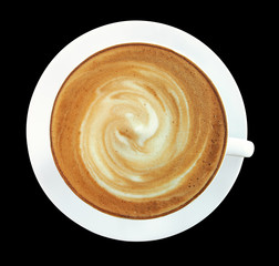 Top view of hot coffee cappuccino cup with spiral milk foam isolated on black background, clipping path included.